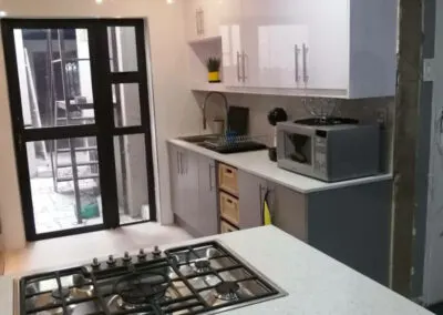 Grey and white kitchen with glass-door cabinets