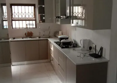 Taupe kitchen cabinetry with a white countertop